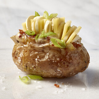 Loaded Baked Idaho® Potato with Mushroom Butter, Truffle Honey, Comté, Benton’s Bacon, Scallions