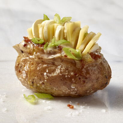Loaded Baked Idaho® Potato with Mushroom Butter, Truffle Honey, Comté, Benton’s Bacon, Scallions