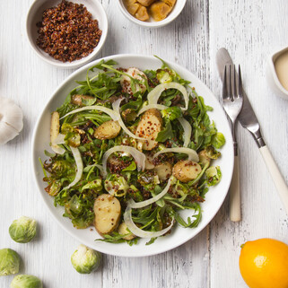 Quinoa Roasted Idaho® Potato & Caramelized Onion Bowl with Arugula & Tahini Lemon Dressing