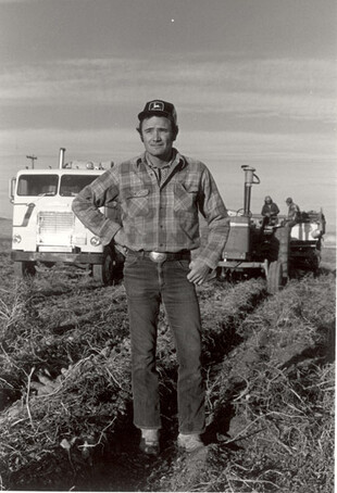 Farmer with tractor behind him