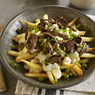 Spring Vegetarian Poutine with Fresh Spring Peas, Black Trumpet Mushrooms and Dill Béchamel