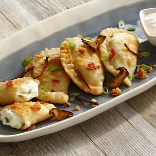 Loaded Potato Pierogi with Mushroom Bacon and Chili Crema