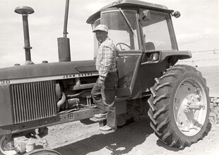 Farmer with enclosed tractor